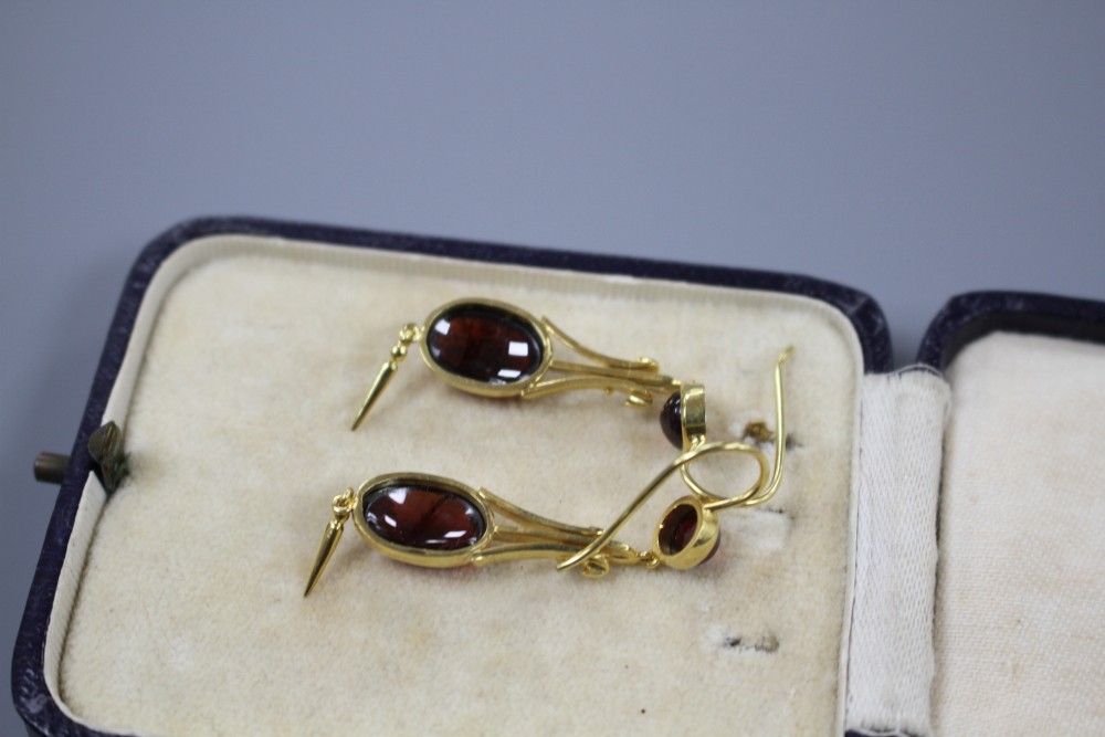 A pair of Victorian style yellow metal and cabochon garnet set drop earrings, overall 50mm, gross weight 5.1 grams.